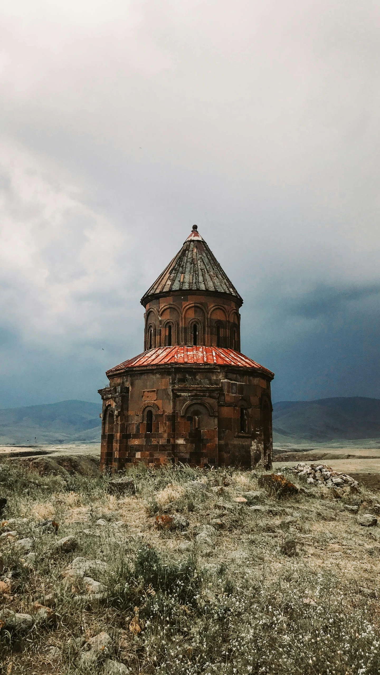 an old building sitting on top of a hill, by Muggur, unsplash contest winner, romanesque, orthodox, demur, cake, brown