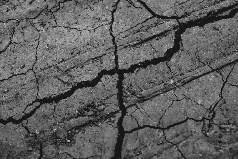 a black and white photo of a crack in the ground, by Mirko Rački, pexels, auto-destructive art, background image, instagram photo, album photo