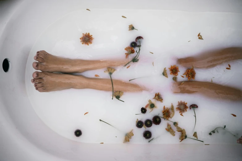 a person laying in a bath filled with flowers, unsplash, legs intertwined, fine art print, 2000s photo, ignant