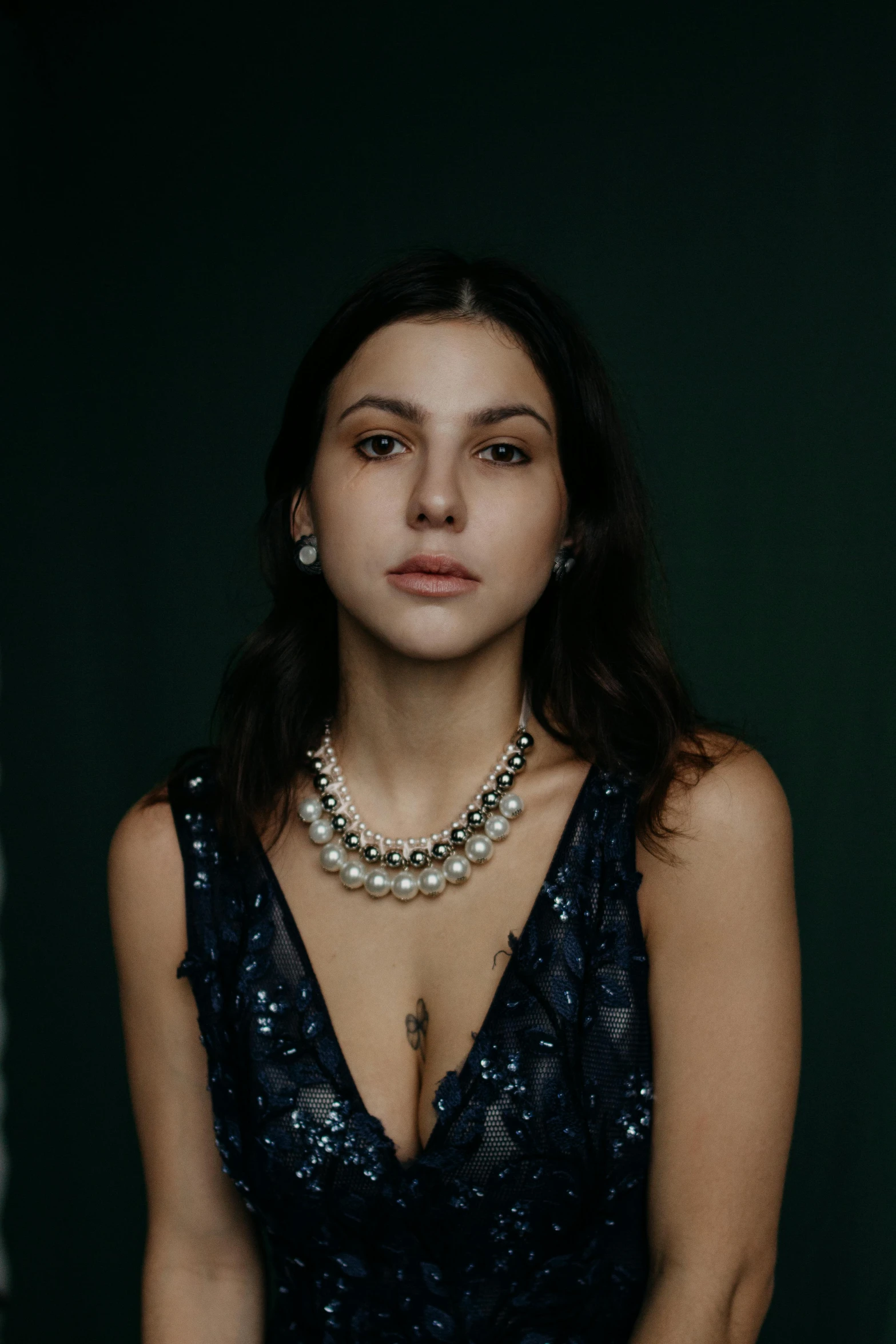 a woman in a blue dress posing for a picture, an album cover, inspired by Elsa Bleda, trending on pexels, photorealism, pearl necklace, portrait sophie mudd, silver，ivory, aged 2 5