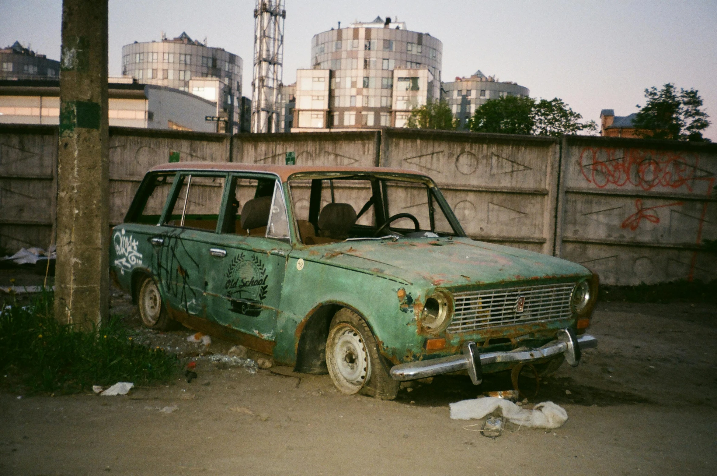 a car that is sitting in the dirt, an album cover, by Attila Meszlenyi, unsplash, auto-destructive art, in moscow centre, photo taken on fujifilm superia, rusty vehicles, suburban