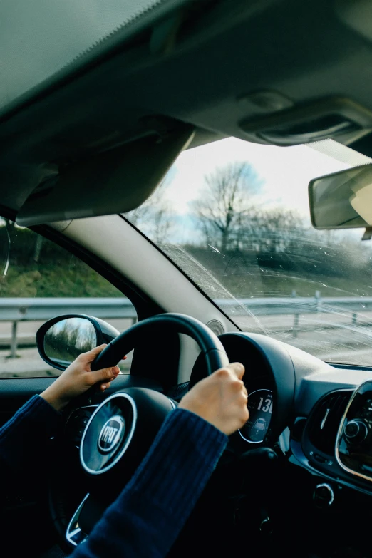 a person driving a car on a highway, detailing, thumbnail, sturdy, premium