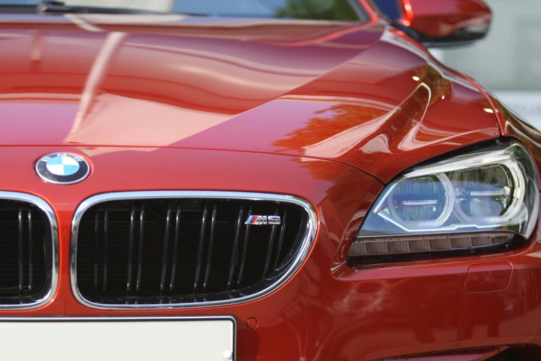 a red bmw car parked in a parking lot, pexels contest winner, photorealism, closeup 4k, brown, chrome and carbon, s line