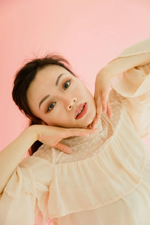 a woman posing for a picture in front of a pink background, by Ayami Kojima, milky white skin, puff sleeves, softfocus, <pointé pose>;open mouth