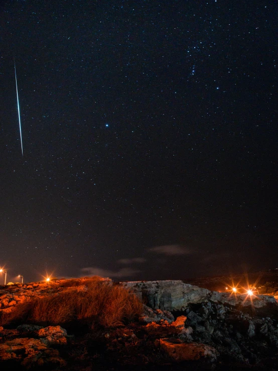 a group of people standing on top of a mountain under a night sky, meteors, shot of a space station at night, profile image, blue fireball