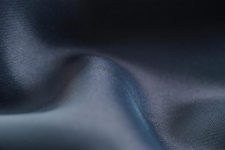 a close up shot of a blue fabric, inspired by Zaha Hadid, unsplash, in gunmetal grey, 4 k smooth, moonlight grey, blurred