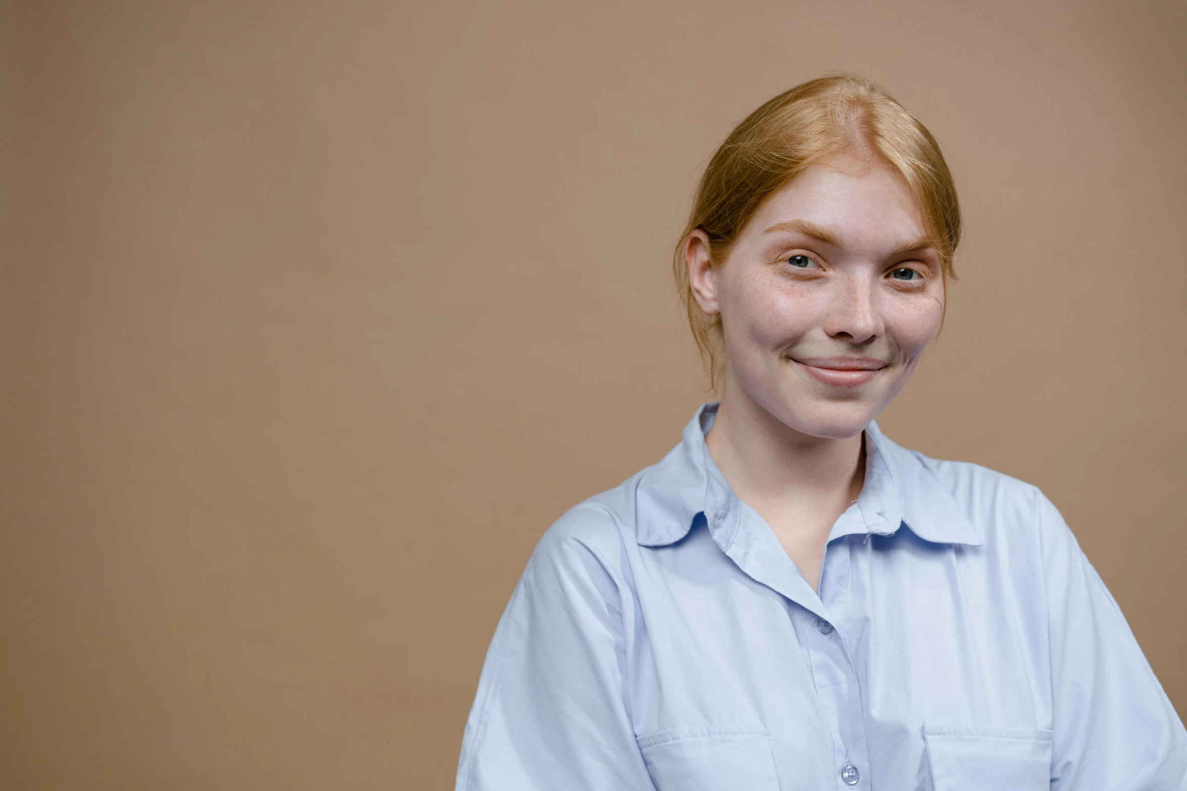 a woman in a blue shirt posing for a picture, a character portrait, by Attila Meszlenyi, trending on pexels, cinnamon skin color, 15081959 21121991 01012000 4k, very pale, student