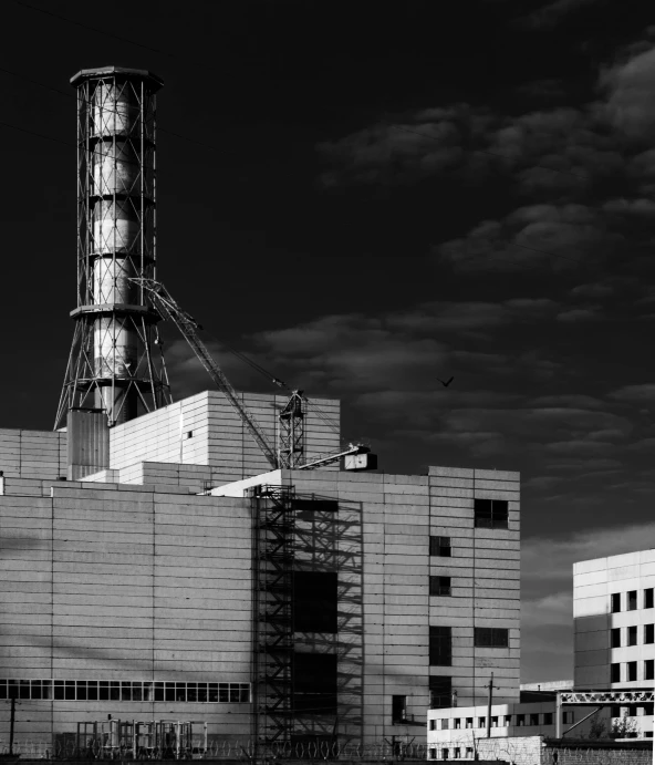 a black and white photo of a factory, unsplash, brutalism, cherenkov radiation, monochrome color, tokio, towering