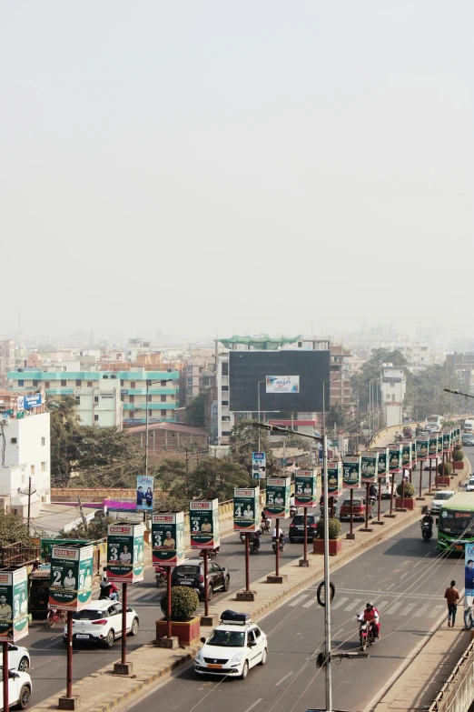 a city street filled with lots of traffic, an album cover, inspired by Zhang Kechun, happening, guwahati, panorama distant view, billboard image, green smoggy sky