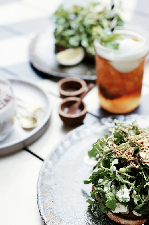 a close up of a plate of food on a table, happening, drinks, greens, australian, subtle details