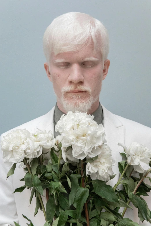 a man in a white suit holding a bouquet of flowers, an album cover, inspired by Graham Forsythe, intense albino, ignant, catalog photo, contemplative