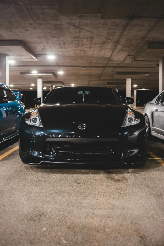 two cars parked next to each other in a parking garage, a photo, by Matt Cavotta, unsplash, full face frontal centered, jdm, square, black car