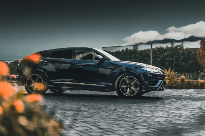 a black lamb suv parked on a cobblestone road, a portrait, by Adam Marczyński, pexels contest winner, lyco art, lamborghini, octane high quality render, performance, side lighting xf iq4