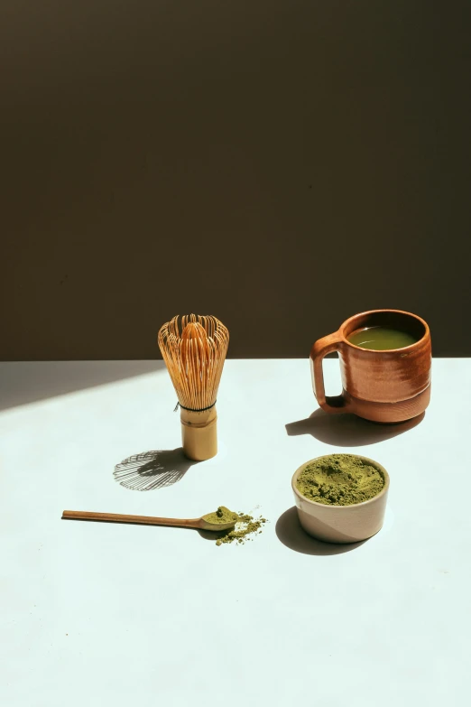 a bowl of matcha next to a cup of matcha and a whisk of matcha, a still life, inspired by Kanō Shōsenin, renaissance, premium, spoon placed, mid shot, collection product