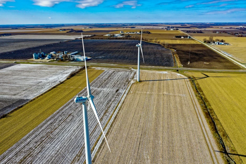 an aerial view of a wind turbine in a field, by Sven Erixson, pexels contest winner, midwest town, background image, maintenance photo, gopro photo