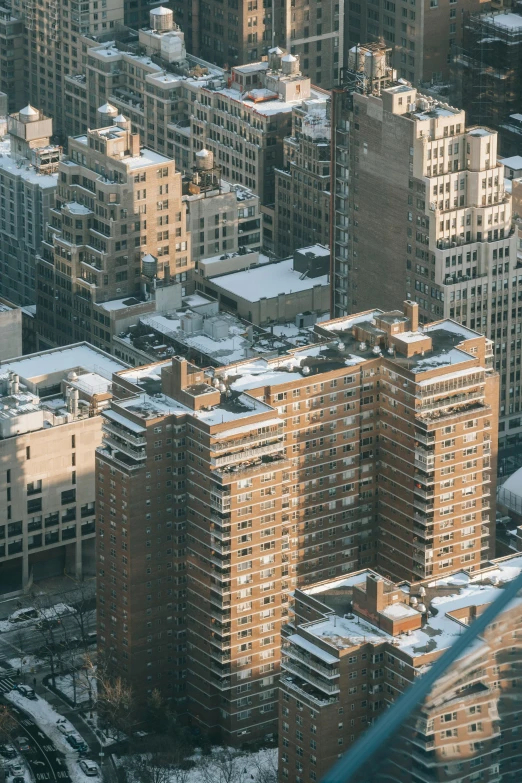 a city filled with lots of tall buildings covered in snow, a photo, pexels contest winner, modernism, rundown new york apartment, isometric 8k, brown, small buildings