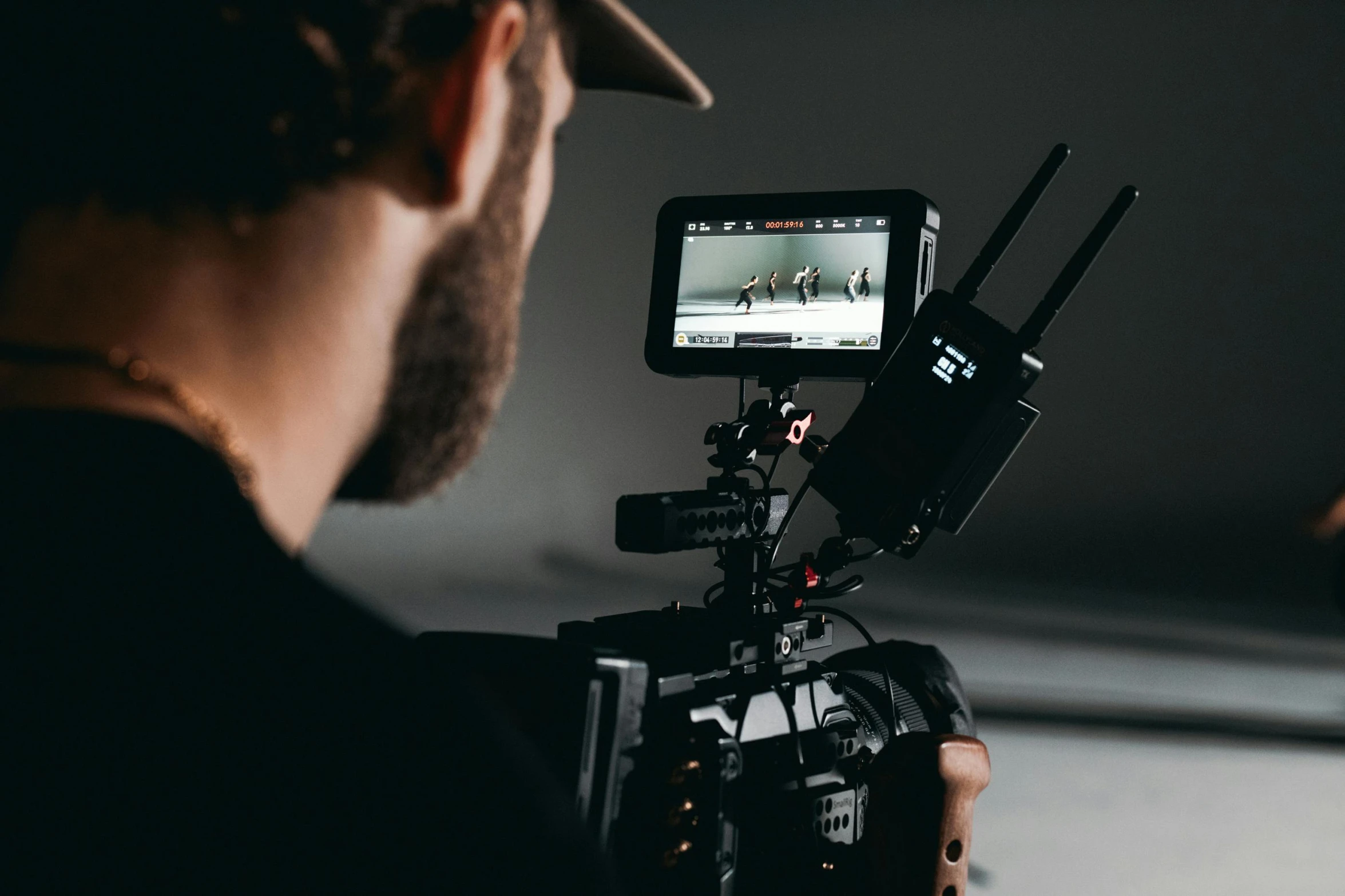 a man that is standing in front of a camera, a picture, close up to the screen, in an action pose, professional product shot, back towards camera