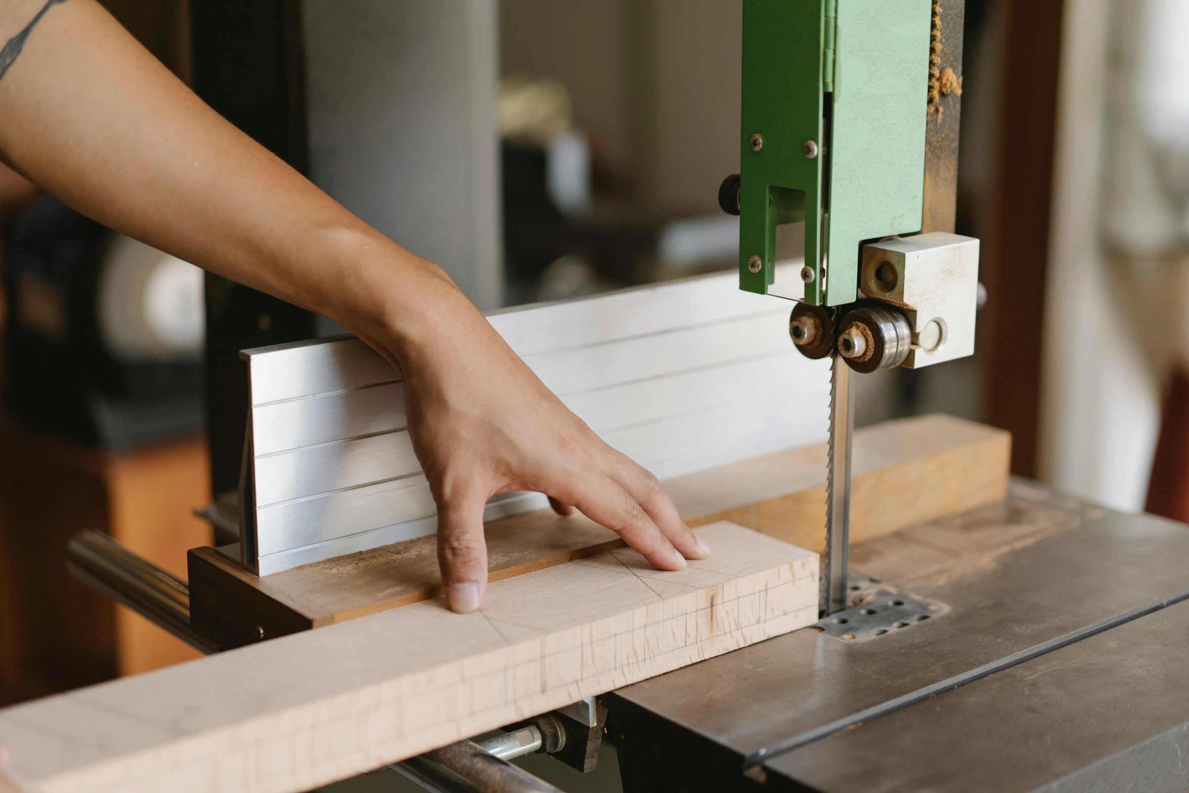 a person using a band saw to cut a piece of wood, trending on pexels, arts and crafts movement, 9 9 designs, lachlan bailey, plating, rectangle