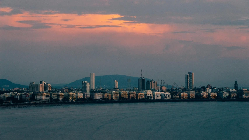 a large body of water with a city in the background, by Daniel Lieske, pexels contest winner, humid evening, seaview, late afternoon, gigapixel photo