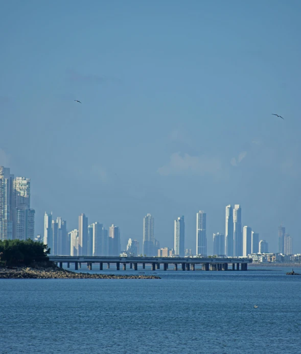 a large body of water with a city in the background, by Carey Morris, pexels contest winner, tall columns, colombian, 15081959 21121991 01012000 4k, all buildings on bridge