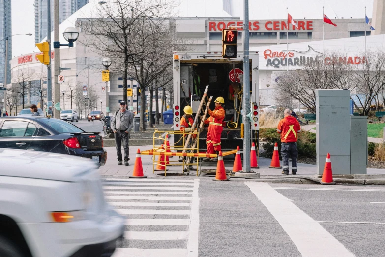 a group of people that are standing in the street, by Chris Rallis, pexels contest winner, maintenance, toronto, cone, worksafe. instagram photo