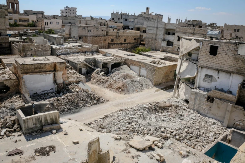 a large pile of rubble sitting in the middle of a city, unsplash, dau-al-set, in the middle of a small colony, 2000s photo