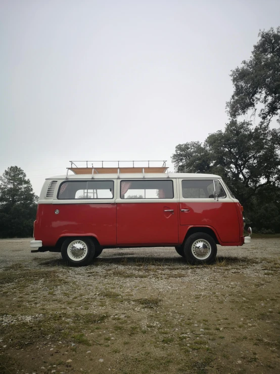 a red and white van parked in a field, unsplash, photorealism, in spain, joel sternfeld, 7 0 s photo, soft top roof raised