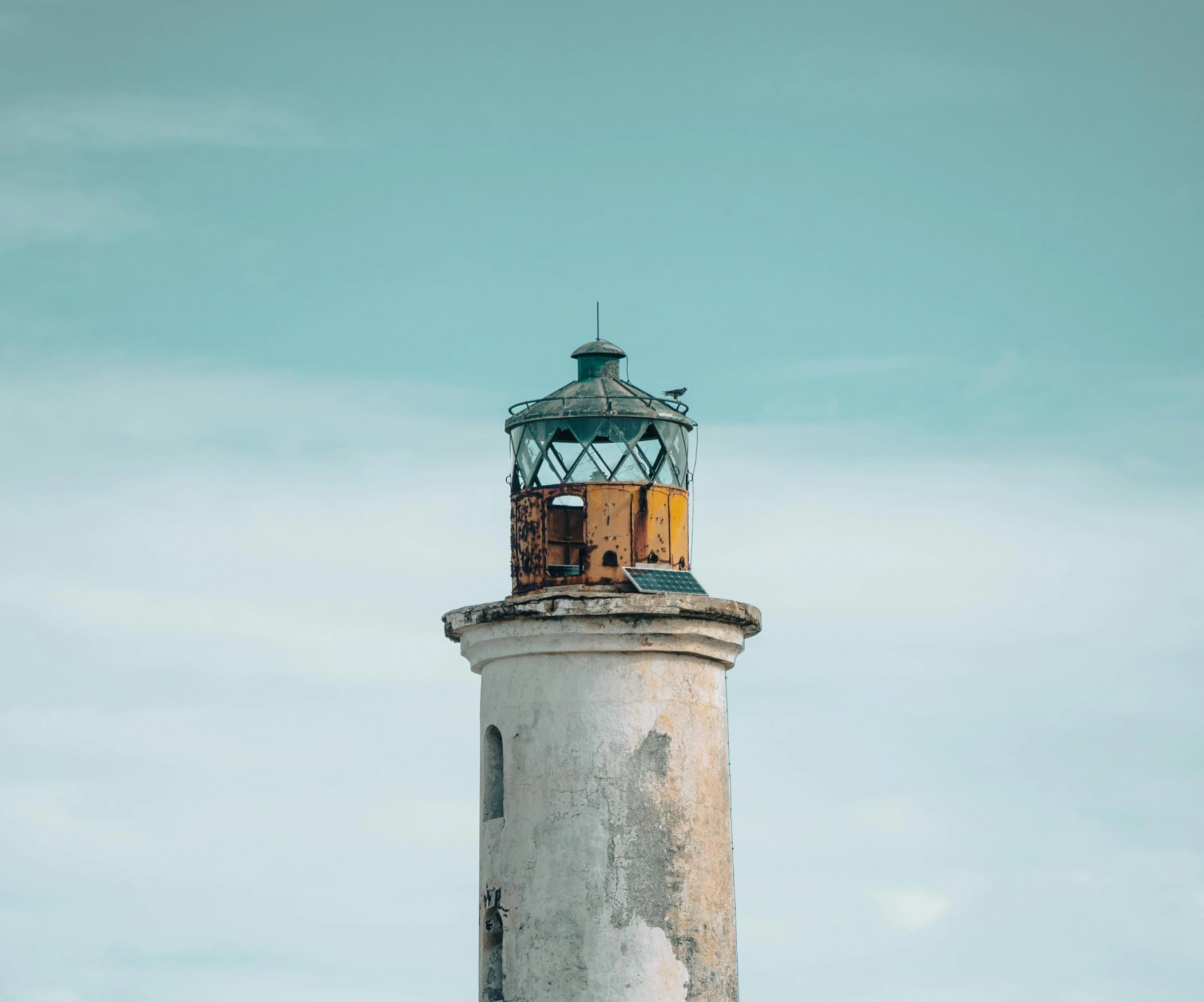 a white lighthouse with a blue sky in the background, a colorized photo, pexels contest winner, minimalism, turquoise rust, deteriorated, moody : : wes anderson, lantern light besides