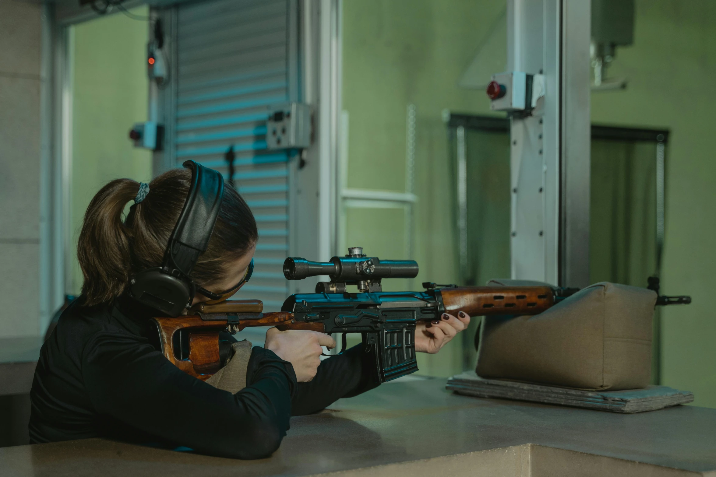 a woman shooting with a rifle in a shooting range, pexels contest winner, escape from tarkov, high angle shot, side profile shot, production ready