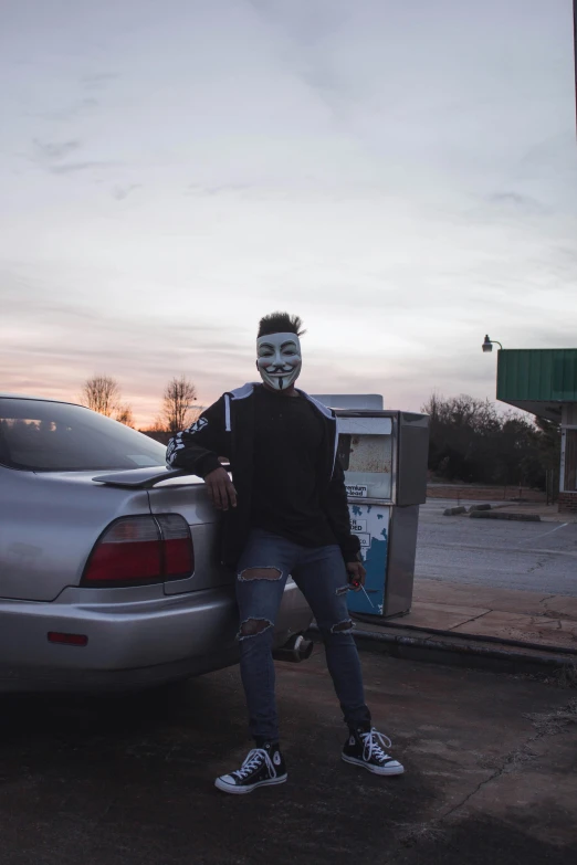 a man in a mask standing next to a car, an album cover, trending on reddit, in louisiana, yasuke 5 0 0 px models, gas station, anonymous