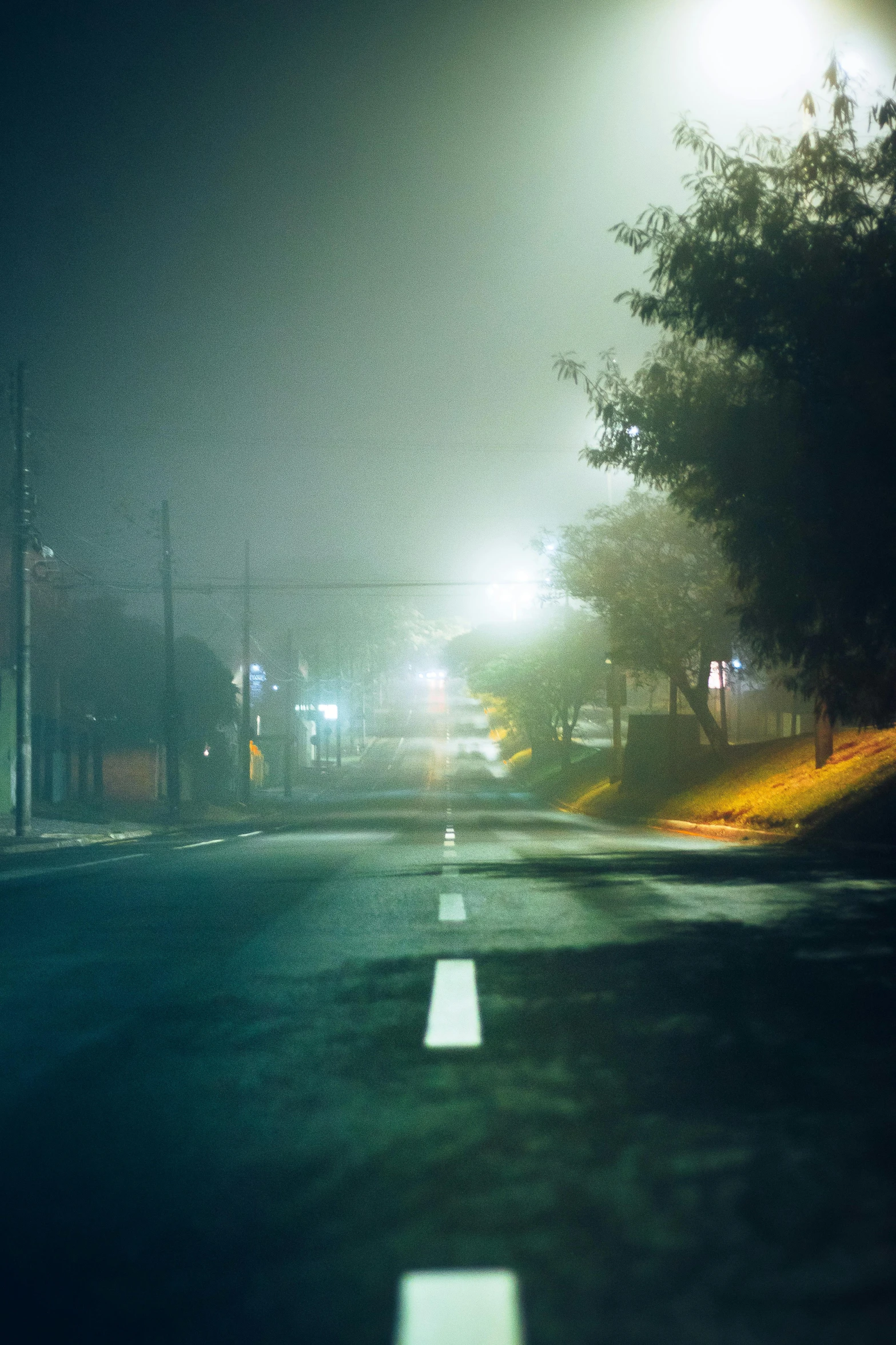 a street filled with lots of traffic at night, an album cover, inspired by Elsa Bleda, realism, morning fog, suburb, foggy photo 8 k, streetscapes