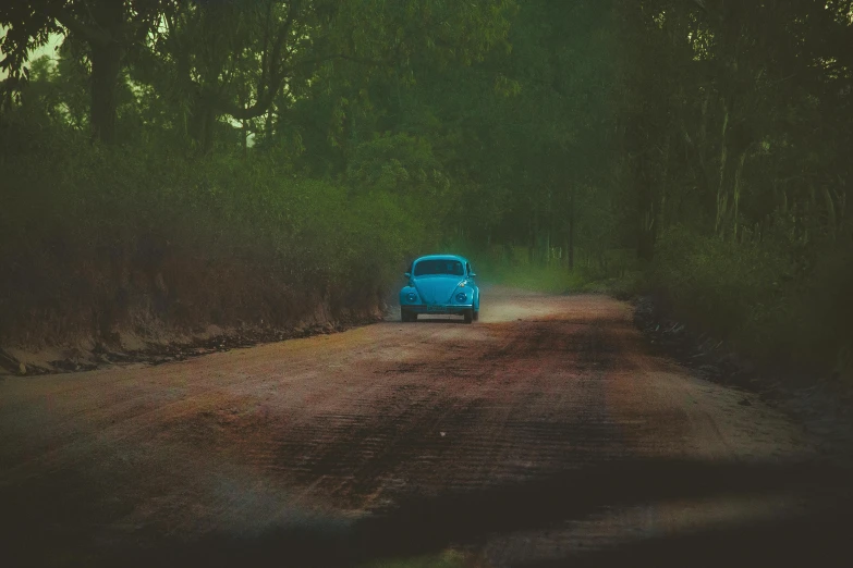 a blue car driving down a dirt road, an album cover, inspired by Elsa Bleda, pexels contest winner, scarab, !!! colored photography, hd wallpaper, murky dusty deep