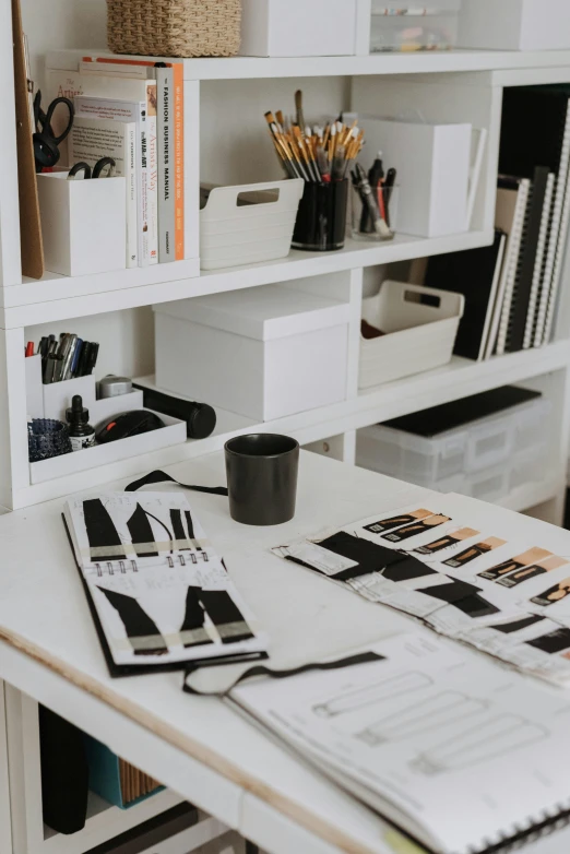 a desk with a lot of office supplies on it, trending on pexels, arbeitsrat für kunst, white and black clothing, beautiful brand labels, overall architectural design, shelf