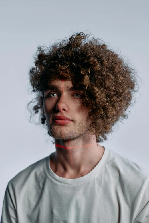 a man with curly hair wearing a white shirt, an album cover, inspired by miles johnston, trending on pexels, attractive androgynous humanoid, who is a male android, 8k octan photo, adam ondra
