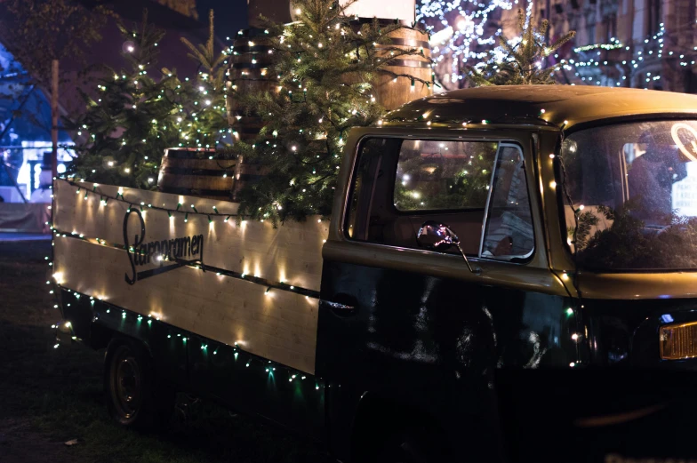 a truck with a christmas tree in the back, a portrait, by Jens Søndergaard, unsplash, summer festival night, 💋 💄 👠 👗, ivy's, historical photo