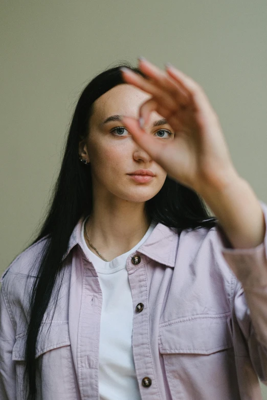 a woman making a stop sign with her hands, an album cover, by Attila Meszlenyi, trending on pexels, straight eyebrows, headshot profile picture, wearing casual clothing, female with long black hair