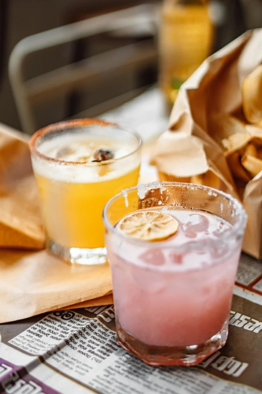 a couple of drinks sitting on top of a table, tacos, daily specials, lemonade, pink