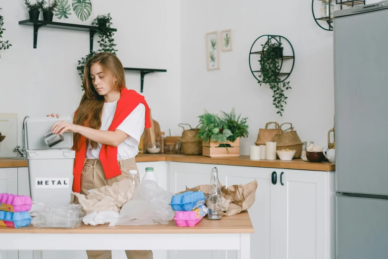 a woman standing in a kitchen preparing food, pexels contest winner, process art, holly herndon origami statue, avatar image, gardening, long hair and red shirt