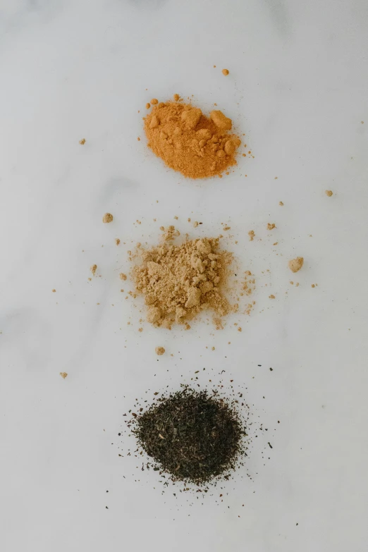 a white plate topped with different types of spices, unsplash, renaissance, three colors, grey orange, crushed, ignant