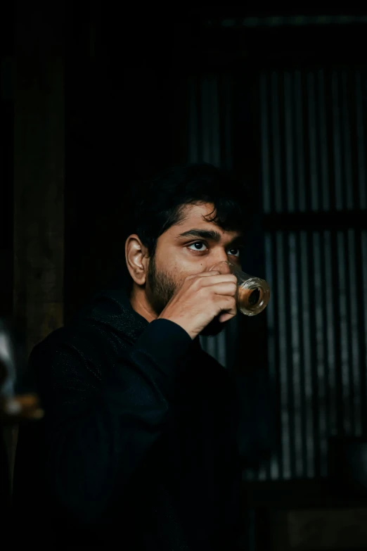 a man drinking a glass of wine in a dark room, an album cover, pexels contest winner, hurufiyya, hindu, headshot profile picture, coffee smell, ((portrait))