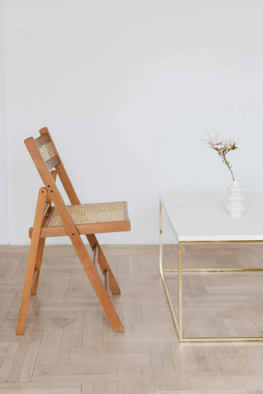 two chairs and a table in a room, inspired by Constantin Hansen, trending on unsplash, white space, inspect in inventory image, wood and gold details, product display photograph