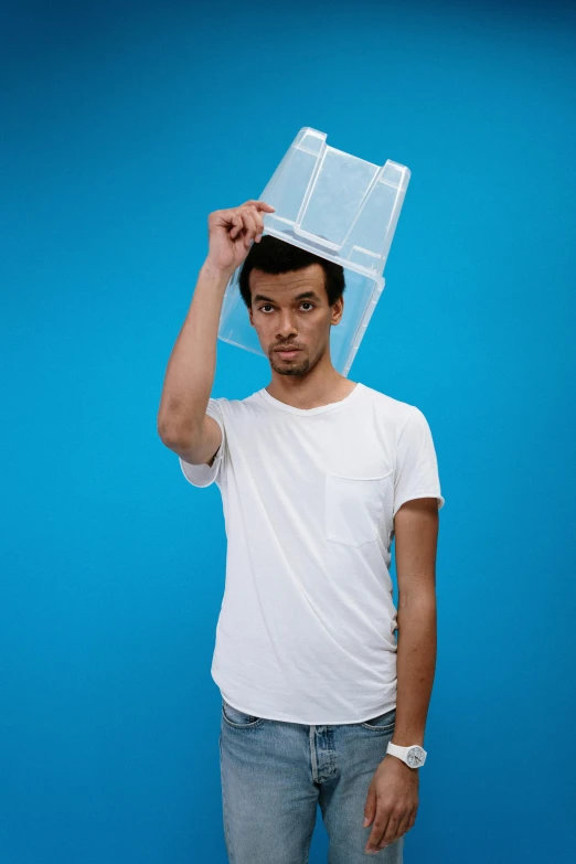 a man with a plastic box on his head, featured on reddit, posing like a falling model, wearing a light shirt, nathan for you, bedhead