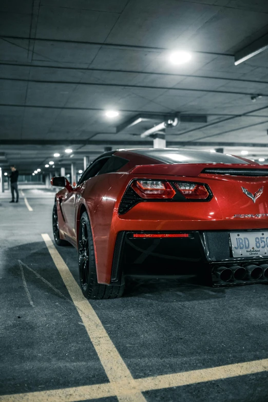 a red sports car parked in a parking garage, by Jason Felix, pexels contest winner, rear lighting, stingray, pathetic, low quality photo