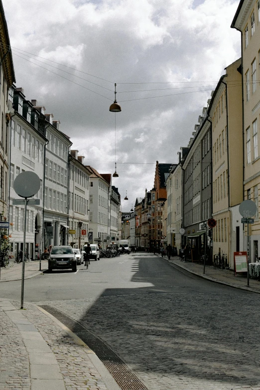 a city street filled with lots of tall buildings, by Christen Købke, pexels contest winner, renaissance, denmark, colonial era street, view from across the street, taken in the late 2010s