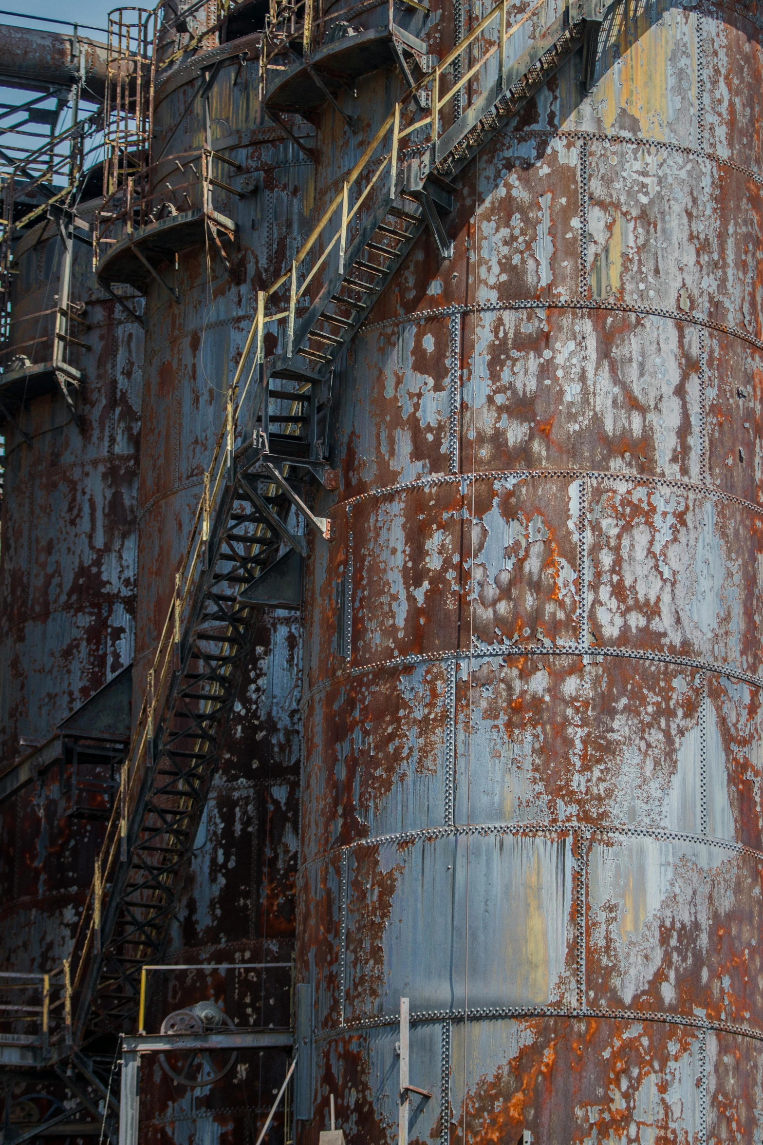 a rusted building with stairs leading up to it, process art, silo, shipyard, paul barson, o'neill cylinder