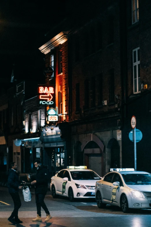 a man riding a skateboard down a street at night, pexels contest winner, happening, outside a saloon, ireland, police cars, gif