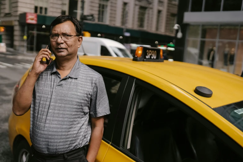 a man talking on a cell phone next to a taxi, pexels contest winner, hindu, in the middle of new york, avatar image, older male