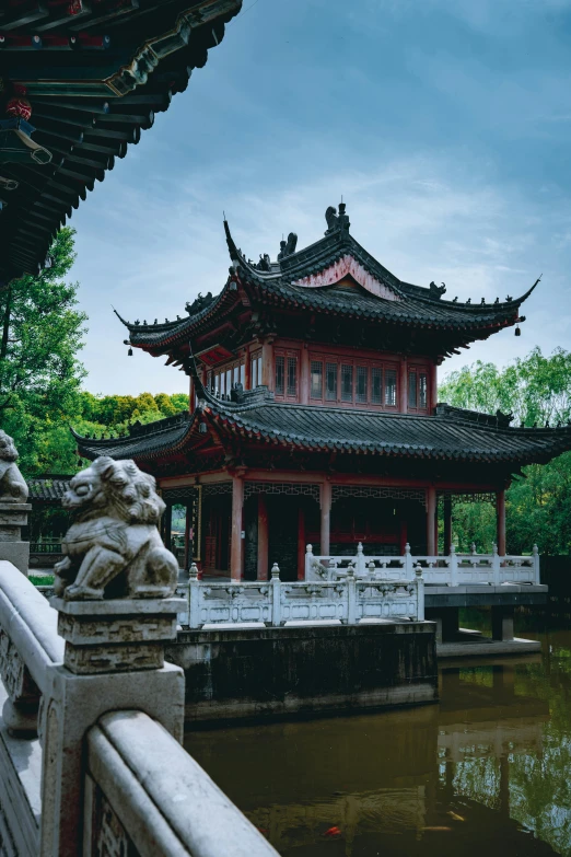 a bridge over a body of water with a building in the background, a statue, inspired by Zhang Zeduan, pexels contest winner, square, color image, gazebos, hou china