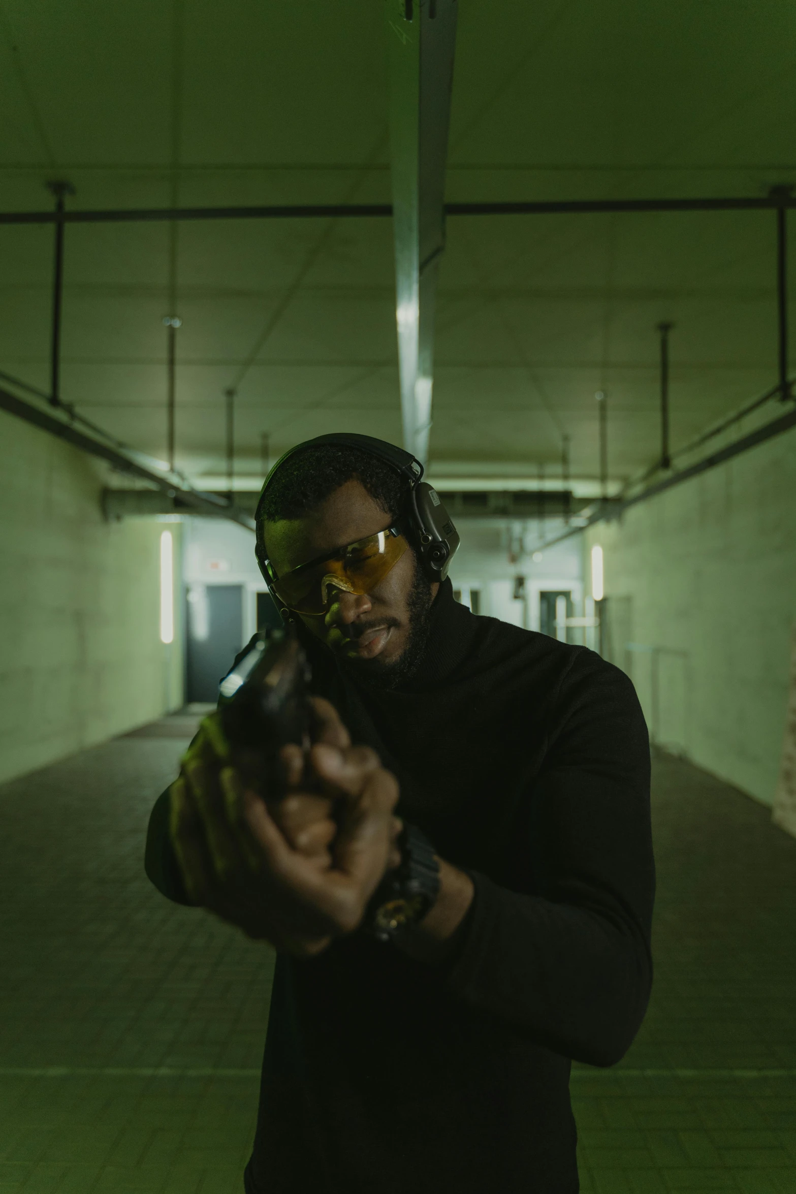 a man in a black shirt holding a gun, inspired by John Carpenter, pexels contest winner, renaissance, black man, with anamorphic lenses, nightvision, ( ( theatrical ) )