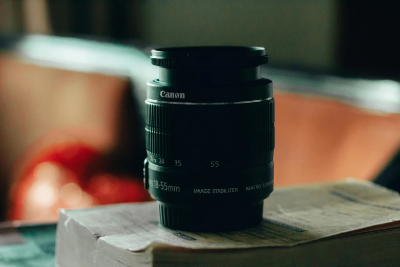 a camera lens sitting on top of a book, unsplash contest winner, photorealism, canon eos rebel, dslr photo of a vase on a table, photographic filter, 55m lens